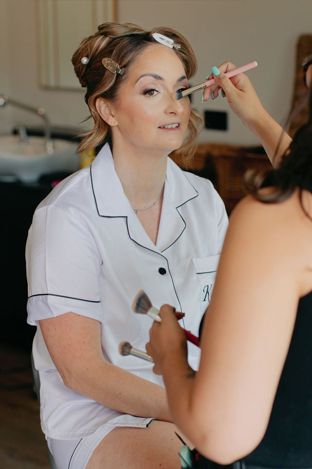 Katie having her makeup finished before the wedding