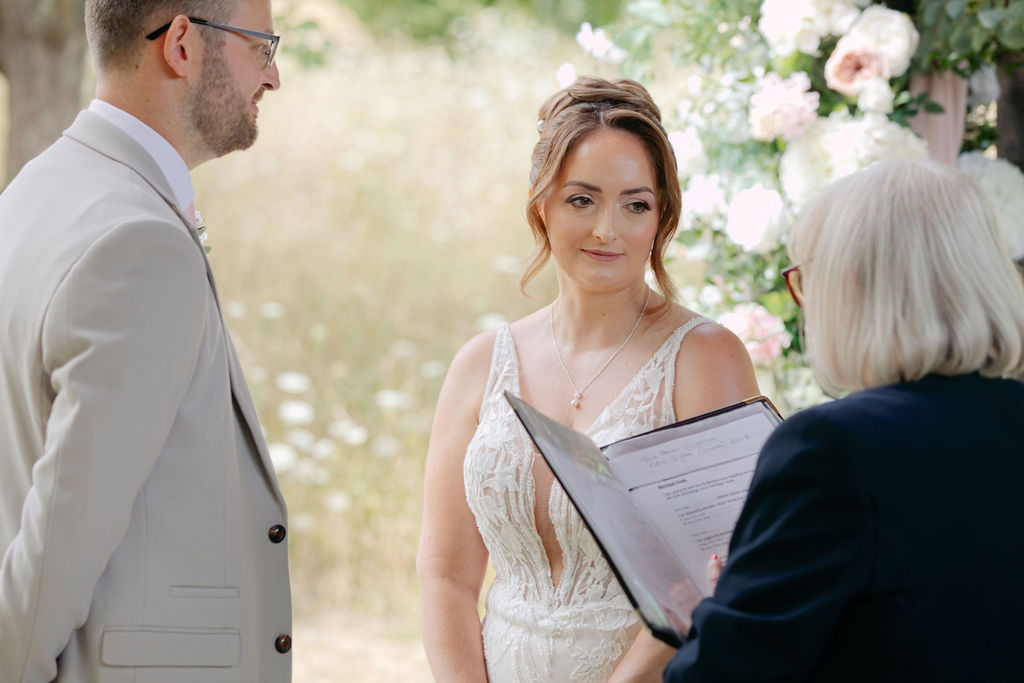 Jack and Katie exchanging vows at their outdoor ceremony