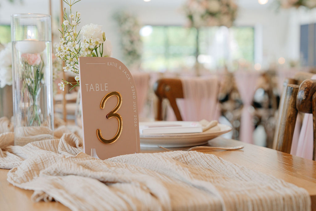 Wedding table number three with glassware and softly coloured linens